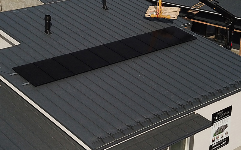Ilmakuva asuntomessukohteesta, mustat aurinkopaneelit katolla